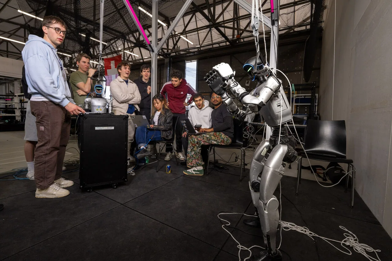 Team interacting with a humanoid robot at the ETHRC Robotics Hackathon in Zurich.